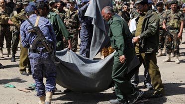 Policemen carry the body of a man, convicted of involvement in the 2018 killing of top Houthi leader Saleh al-Samad, after his execution at Tahrir Square in Sanaa, Yemen. (Reuters)