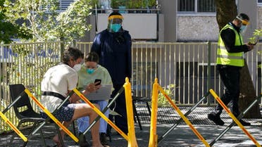 A health worker speaks with a member of the public at a coronavirus disease (COVID-19) vaccination clinic set up for residents of surrounding public housing towers in the Redfern suburb, where authorities are working to contain an emerging cluster of cases, as widespread lockdown continues in Sydney, Australia, September 17, 2021. (Reuters)