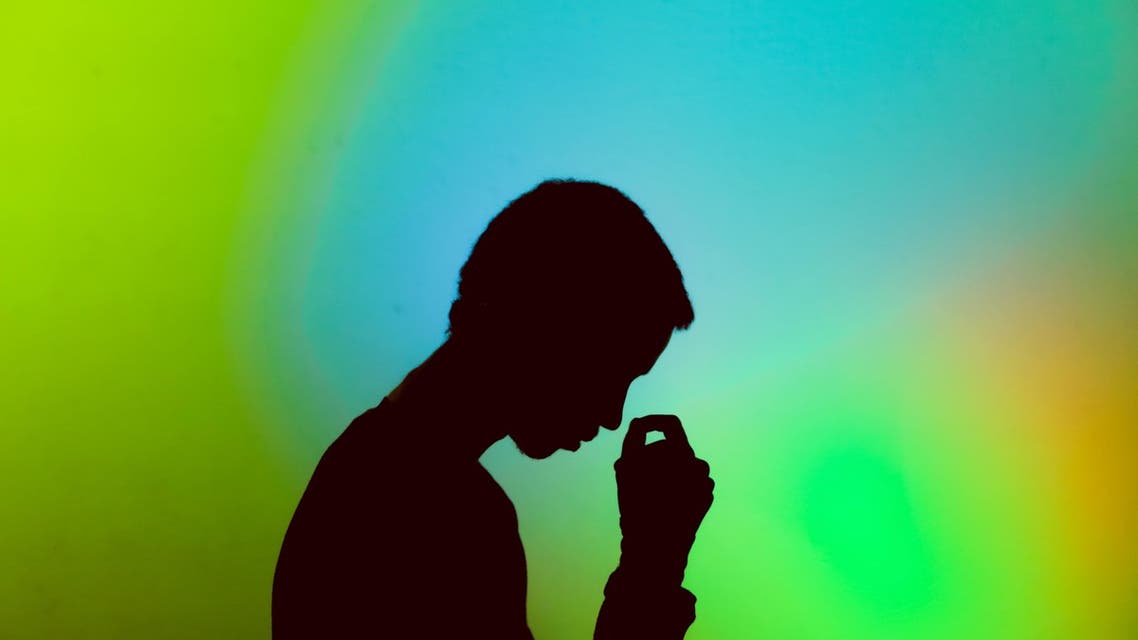 A man standing in front of a colorful background, thinking. (Unsplash, Gift Habeshaw)