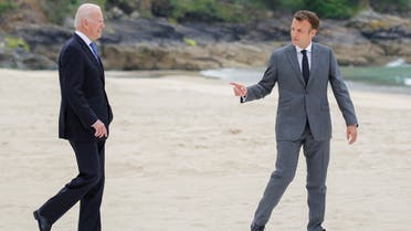 US President Joe Biden and France's President Emmanuel Macron walk along the boardwalk during the G7 summit in Carbis Bay, Cornwall, Britain, June 11, 2021. (Reuters)