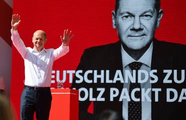 German Finance Minister, Vice-Chancellor, and the Social Democratic Party's (SPD) chancellor candidate Olaf Scholz waves to supporters during a rally in Munich, southern Germany, on September 18, 2021. (AFP)