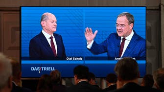 Who are the two men trying to replace Germany’s Angela Merkel? 
