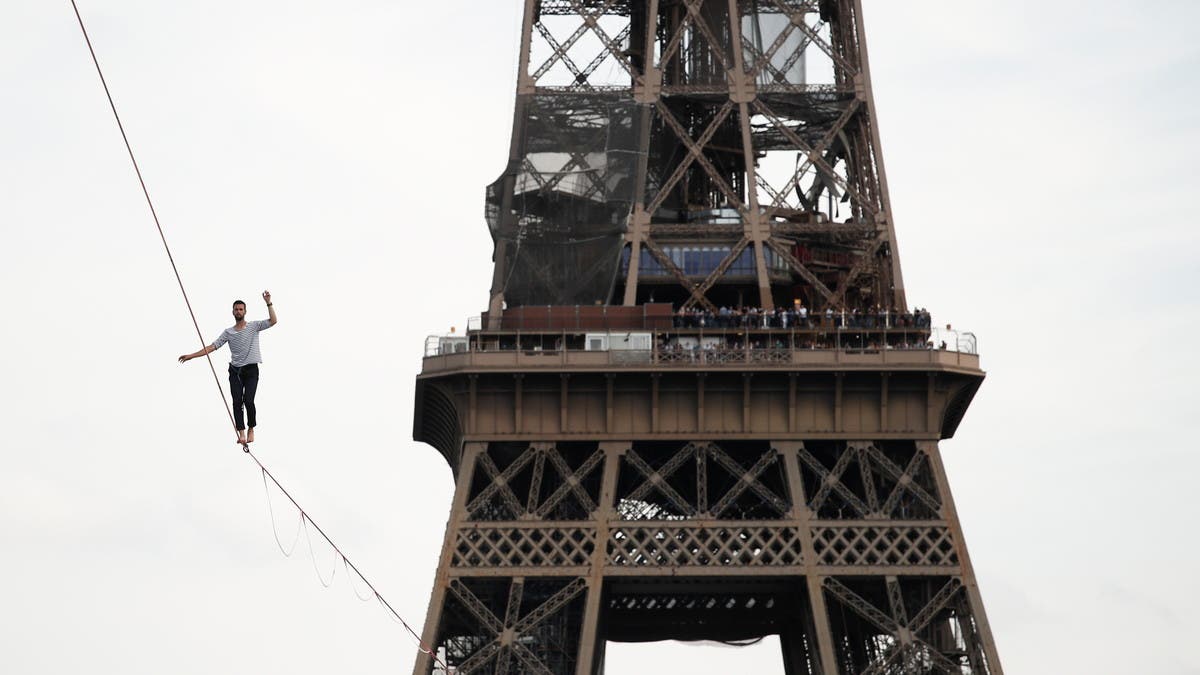 Eiffel Tower evacuated after man scales world-famous monument