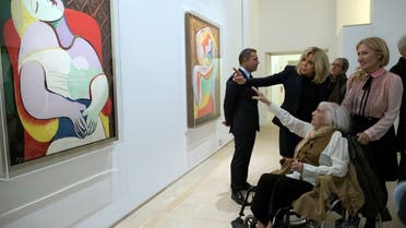 Brigitte Macron, the wife of the French President, talks with daughter of Spanish painter Pablo Picasso, Maya Picasso (bottom), and her son Olivier (L) and daughter Diana (R) during a visit of the Picasso 1932: Erotic Year exhibition at the Picasso Museum in Paris, France, October 8, 2017. (Reuters)