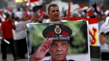  A supporter of former prime minister and presidential candidate Ahmed Shafik holds a poster of Field Marshal Mohamed Hussein Tantawi, the head of the ruling Supreme Council of the Armed Forces (SCAF) during a rally in front of the military parade stand at Nasr City in Cairo June 23, 2012. (File photo: Reuters)