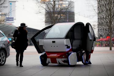 A woman poses for photographers beside a prototype driverless car called a LUTZ (Low-carbon Urban Transport Zone) Pathfinder Pod during a launch event for the media. (File photo: AP)9973
