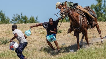 US Border Patrol agent on horseback tries to stop a Haitian migrant from entering in Del Rio, Texas, Sept. 19, 2021. (AFP)