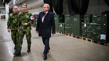 Swedish Defense Minister Peter Hultqvist (R) visits the site of a new field hospital for COVID-19 patients the military is building at the Stockholm International Fairs facility on March 27, 2020 in Stockholm.(Jonathan Nackstrand/AFP)