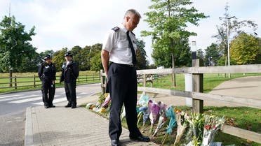 Chief Superintendent Trevor Lawry stands by the floral tributes at Cator Park in Kidbrooke, near to the area where the body of Sabina Nessa was found, in London, on Sept. 23, 2021. (AP)