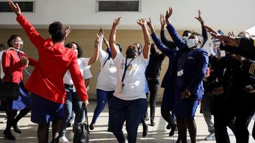 Workers sing and dance as a South African Airways (SAA) airplane prepares to take off after a year-long hiatus triggered by the national airline running out of funds, at O.R. Tambo International Airport in Johannesburg, South Africa, on September 23, 2021. (Reuters)