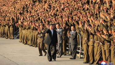 This picture taken on September 9, 2021 and released from North Korea's official Korean Central News Agency (KCNA) on September 10 shows North Korean leader Kim Jong Un (C) taking part in a photo session with participants in the military parade in Pyongyang. (AFP)