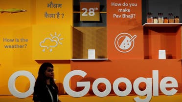 A woman walks past the logo of Google during an event in New Delhi, India. (Reuters)