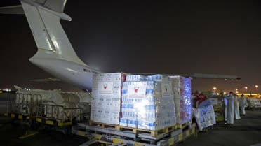 Workers and volunteers load a shipment of humanitarian aid to be sent to Afghanistan at Bahrain International Airport on Muharraq Island, near the capital Manama, on September 4, 2021. (AFP)