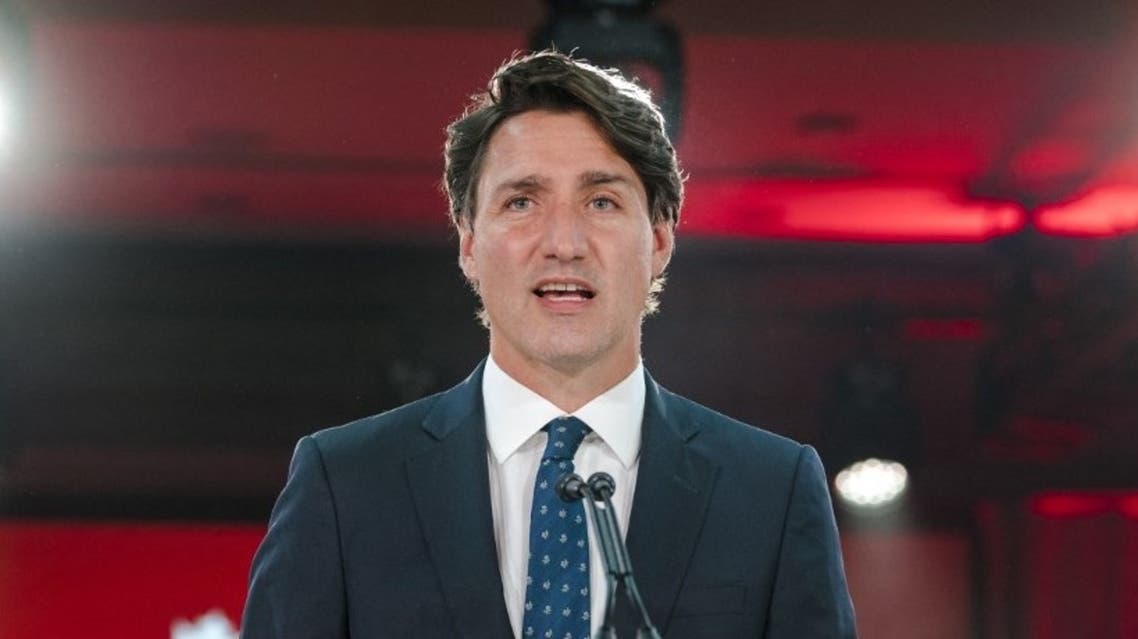 Canadian Prime Minister Justin Trudeau, flanked daughter Ella-Grace, delivers his victory speech after general elections at the Fairmount Queen Elizabeth Hotel in Montreal, Quebec, early on September 21, 2021. (AFP)