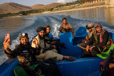 Taliban fighters enjoy a boat ride in the Qargha dam, outskirt of Kabul, Afghanistan, Sept. 24, 2021. (AP)