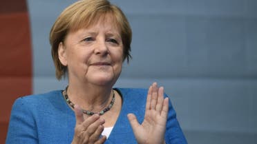 German Chancellor Angela Merkel applauds during a campaign rally for Christian Democratic Union CDU leader and chancellor candidate Armin Laschet (not pictured) in Aachen, western Germany, on September 25, 2021, one day ahead of the German federal elections. (AFP)