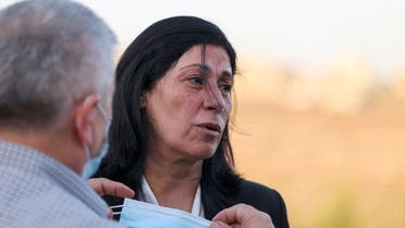 Palestinians welcome lawmaker Khalida Jarrar in Ramallah city in the occupied West Bank, on September 26, 2021, following her release from an Israeli prison. (AFP)