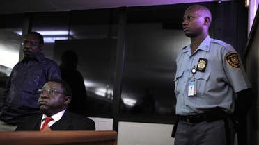 Former Rwanda army's Colonel Theoneste Bagosora (L) reacts in court as he awaits on December 18, 2008 the handing down of the verdict on charges of genocide. (AFP)
