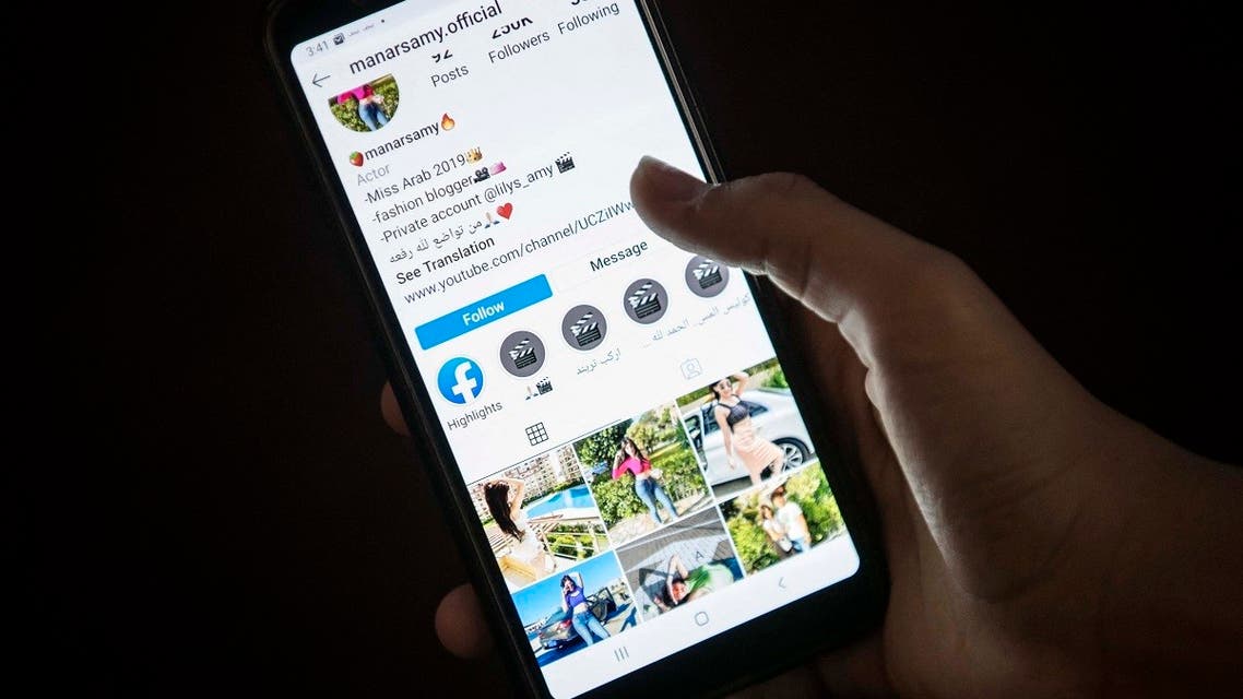 A woman browses the Instagram account of social media influencer Manar Samy, who was sentenced to three years over online videos that were deemed as inciting debauchery, immorality and stirring up instincts, in Egypt's capital Cairo on July 29, 2020. (AFP)