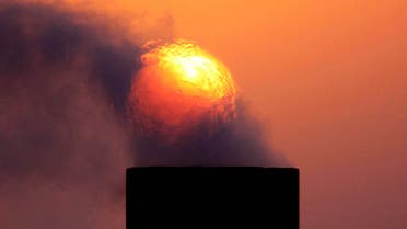 In this Wednesday, Sept. 9, 2009 file photo, smoke rises from an oil pipe at sunset in the desert oil field of Sakhir, Bahrain. (AP)