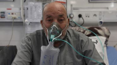 Afghan citizen Zamen Mousavi, a Covid-19 patient breathes with oxygen mask at the COVID-19 ICU ward of Amir Al-Momenin hospital in the city of Qom, some 80 miles (125 kilometers) south of the capital Tehran, Iran, Wednesday, Sept. 15, 2021. (AP)