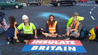 Members of Insulate Britain, demanding that the British government helps provide insulation for 29 million homes, block part of the M25 motorway near London, Britain, on September 20, 2021. (Reuters)