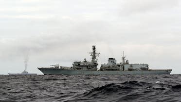 This is a handout photo issued by Britain's Ministry of Defence taken on Wednesday Oct. 19, 2016, of HMS Richmond, foreground, a Type 23 Duke Class frigate, observing aircraft carrier Admiral Kuznetsov, at rear left, which is part of a Russian task group, during transit through the North Sea. Britain is sending warships to watch a Russian aircraft carrier group and other vessels as they sail through the North Sea and the English Channel. Defense Secretary Michael Fallon says that the military will watch the “every step of the way.’’ (PO(Phot) Dez Wade/MoD/Crown Copyright via AP)