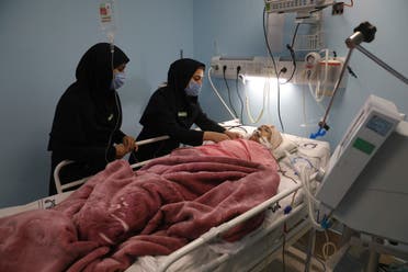 COVID-19 patient Marhamat Asadi, who is in a medically induced coma, is tended by nurses Fatemeh Najmeh Sadeghi, left, and Fereshteh Babakhanlou, at the COVID-19 ICU ward of Amir Al-Momenin hospital in the city of Qom, some 80 miles (125 kilometers) south of the capital Tehran, Iran, Wednesday, Sept. 15, 2021. (AP)