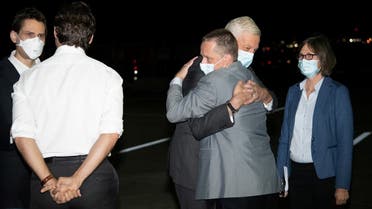 Michael Kovrig and Michael Spavor, accompanied by Canada's Ambassador to China, Domenic Barton, are greeted on arrival by Prime Minister Justin Trudeau after being released from detention in China, in Calgary, Alberta, Canada September 25, 2021. (Reuters)