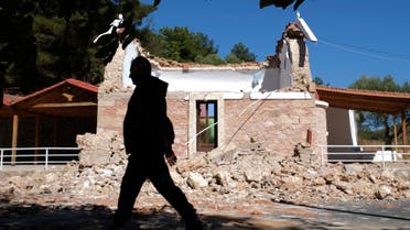 A resident passes next to a damaged Greek Orthodox chapel after a strong earthquake in Arcalochori village on the southern island of Crete, Greece, Monday, Sept. 27, 2021. (AP)