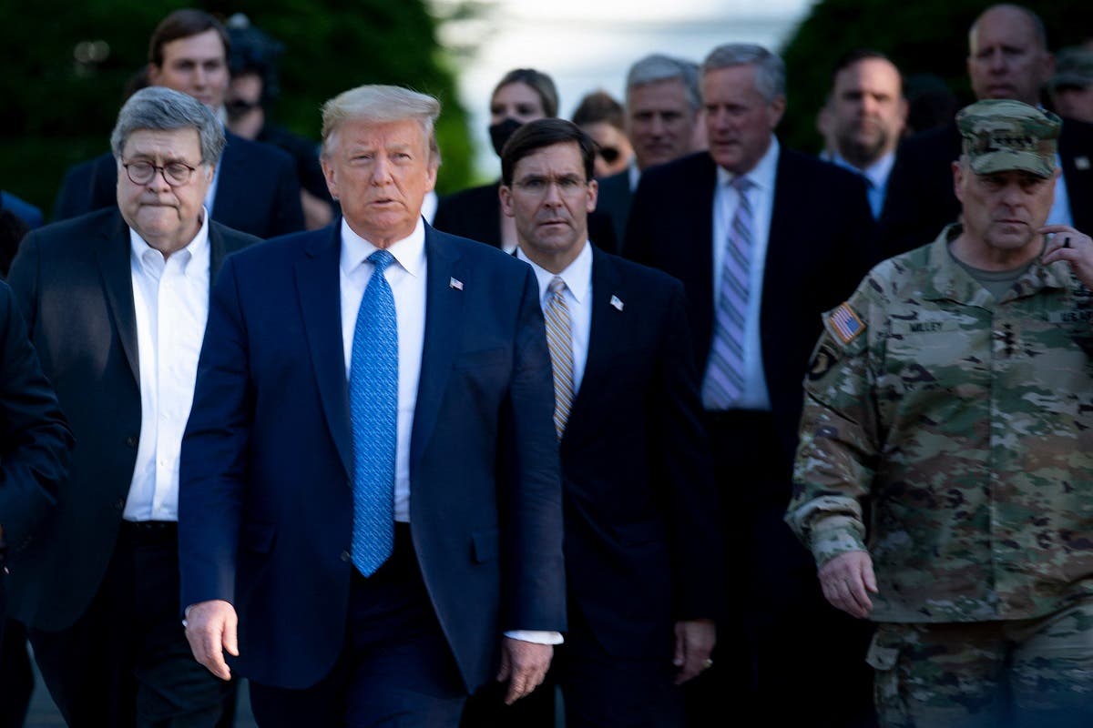 US President Donald Trump walks alongside Chairman of the Joint Chiefs of Staff Mark A. Milley (R), and others from the White House to visit St. John's Church, June 1, 2020. (AFP)