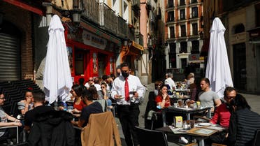 People have lunch at the terrace of a restaurant, amid the coronavirus disease (COVID-19) pandemic, in Madrid, Spain, March 22, 2021. (Reuters)