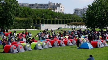 Homeless people, including many migrants, set up a camp in the Andre-Citroen park, near the Ile-de-France region prefecture, on September 1, 2021, in Paris, as part of an action supported by associations' collective “Collectif Requisition” to demand housing solutions. (AFP)