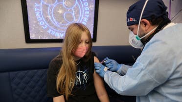 Parsia Jahandani gives Savannah, 12, hepatitis, HPV, and meningitis vaccines at a back-to-school coronavirus disease (COVID-19) and other vaccination clinic, in Westminster, California, US, on August 19, 2021. (Reuters)