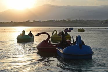 In this photograph taken on September 28, 2021 Taliban fighters ride on paddle boats at Qargha Lake on the outskirts of Kabul. (AFP)