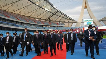 Cambodia’s Prime Minister Hun Sen (centre R) and Chinese Foreign Minister Wang Yi (centre L) walk following a handover ceremony of the Morodok Techo National Stadium, funded by China’s grant aid under its Belt and Road Initiative, in Phnom Penh on September 12, 2021. (AFP)