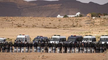 A file photo shows Moroccan security forces stand guard as Moroccan farmers protest in the city of Figuig on March 18, 2021, after Algerian authorities expelled the date growers from the Algerian territory, a border area they are traditionally authorized to farm. (Fadel Senna/AFP)