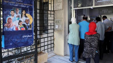 People wait to get the coronavirus disease vaccine in Damascus, Sept. 29, 2021. (Reuters)