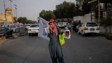 A street vendor sells Taliban and Afghan flags on a street in Kabul, Afghanistan, on Sept. 30, 2021. (AP)