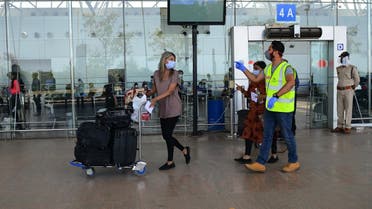 A British national arrives at the departure terminal before boarding a special British Airways flight bound to London during a government-imposed nationwide coronavirus lockdown at the Sardar Vallabhbhai Patel International (SVPI) airport in Ahmedabad on April 15, 2020. (Sam Panthaky/AFP)