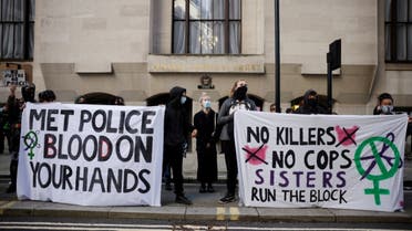 Demonstrators hold banners as they await the sentencing of British police officer Wayne Couzens for the murder of Sarah Everard, outside the Old Bailey court in London on September 29, 2021. (AFP)