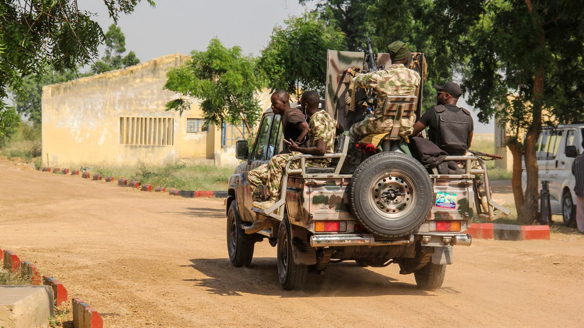 Nigerian Army soldiers are seen driving on a military vehicle in Ngamdu, Nigeria, on November 3, 2020.