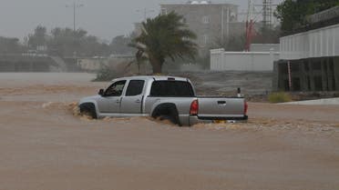 A SUV makes it way through a flooded street as Cyclone Shaheen makes landfall in Muscat Oman, October 3, 2021. (Reuters)