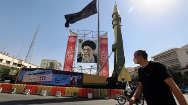 A Shahab-3 surface-to-surface missile is displayed next to a portrait of Iranian Supreme Leader Ayatollah Ali Khamenei, Sept. 25, 2021. (AFP)