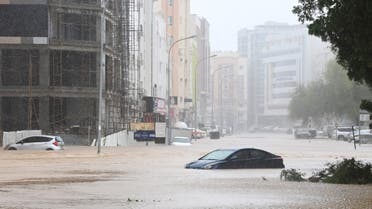 Cars are seen abandoned on a flooded street as Cyclone Shaheen makes landfall in Muscat Oman, October 3, 2021. (AFP)