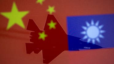 Chinese and Taiwanese national flags are displayed alongside a military airplane in this illustration taken April 9, 2021. (Reuters)
