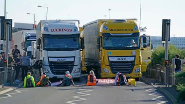  Protesters from Insulate Britain block the A20 road which provides access to the Port of Dover, in Kent, England, Friday, Sept. 24, 2021. (AP)