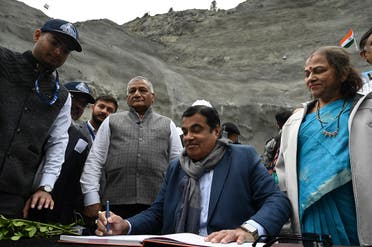 India’s Union Minister of Road Transport and Highways (MoRTH) Nitin Gadkari (C), signs a register as inspects the Zojila tunnel under construction which connects Srinagar to the union territory of Ladakh, at Baltal, some 93 km northeast of Srinagar, on September 28, 2021. (AFP)