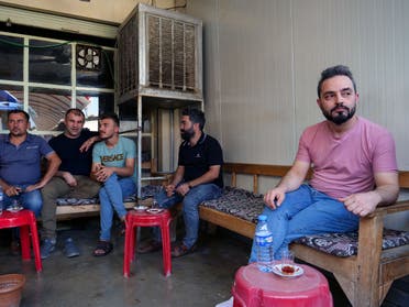 Abdullah Omar, a barber who has many relatives and friends who left to Belarus sits in a local tea shop in the town of Shiladze, Iraq September 22, 2021. (Reuters)