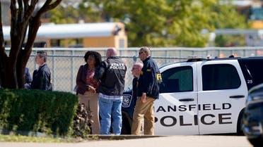 Law enforcement officers from different agencies gather in the parking lot of Timberview High School after a shooting inside the school located in south Arlington, Texas, Wednesday, Oct. 6, 2021. (AP/LM Otero)